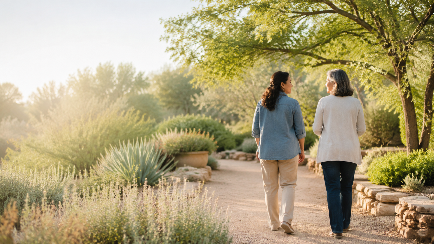 Two women walking together along a peaceful garden path